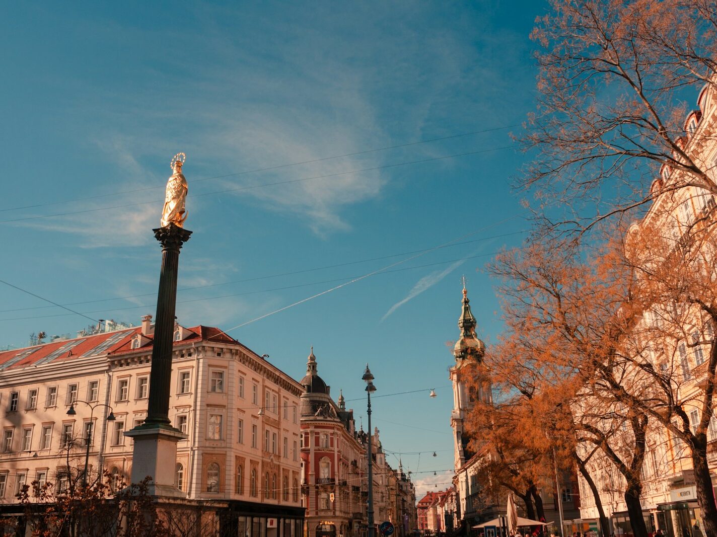 a city street with tall buildings and a clock tower