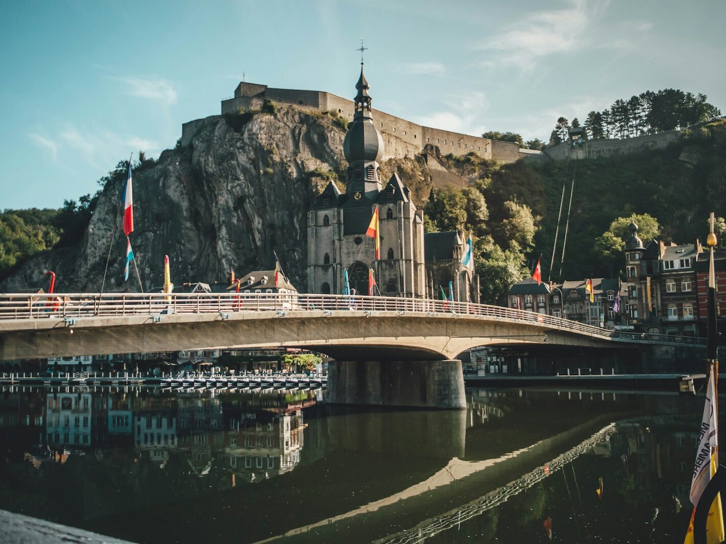 a bridge over a body of water with a castle in the background