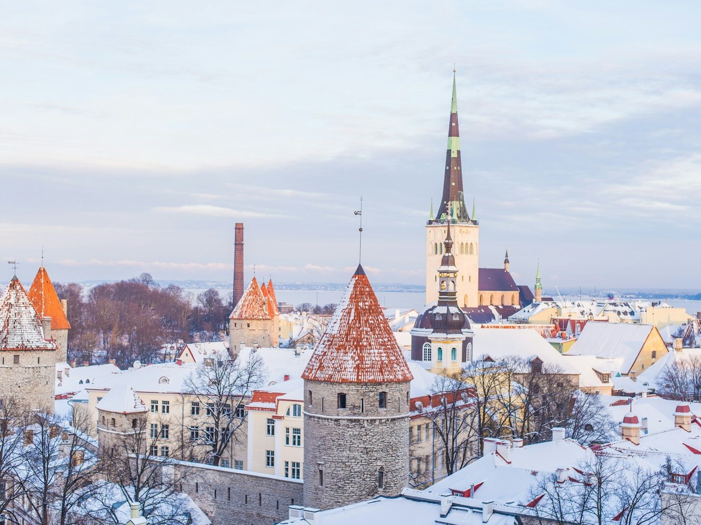 snow covered brown, white, and gray concrete castle under cloudy skies
