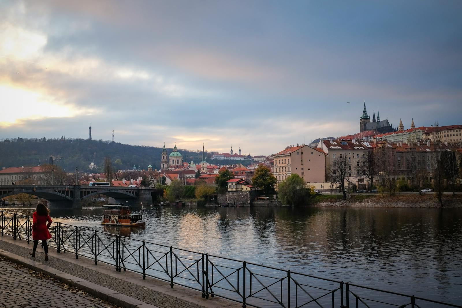 Stunning view of Prague's cityscape featuring Charles Bridge and Prague Castle during a serene twilight moment.