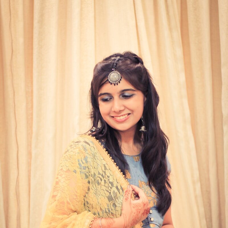 a woman in a yellow and blue sari