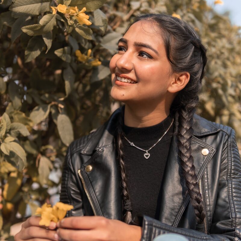 woman in black leather jacket smiling