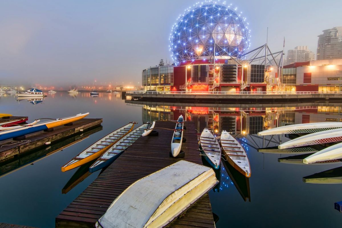 Enchanting view of Vancouver's Science World reflecting on calm waters at twilight.