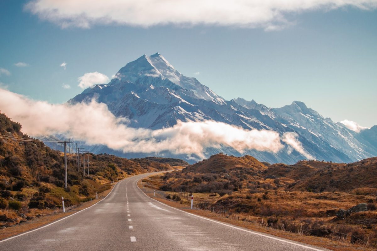 grey road in behind mountain