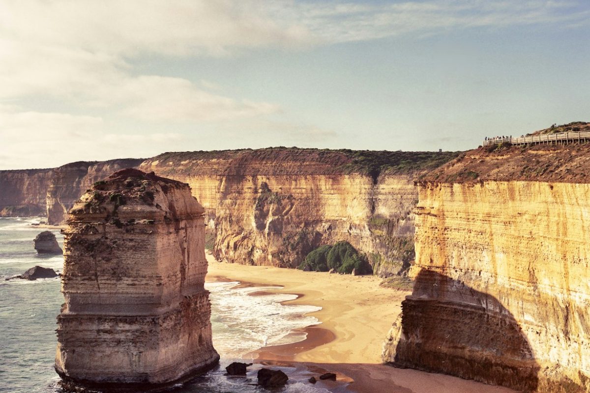 beige rock on body of water