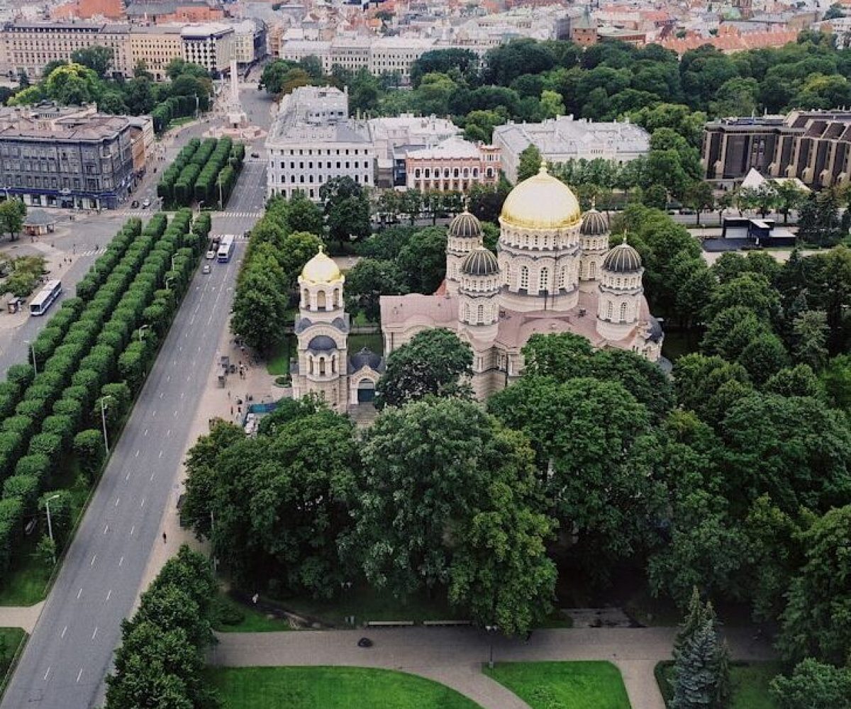 aerial view of city with garden and dome building