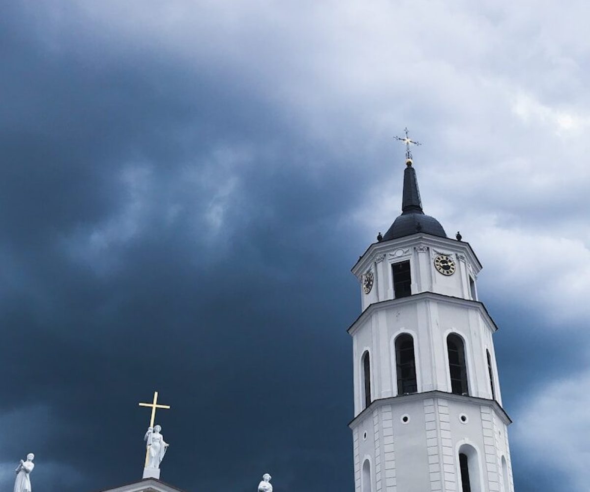 white and black church under blue sky