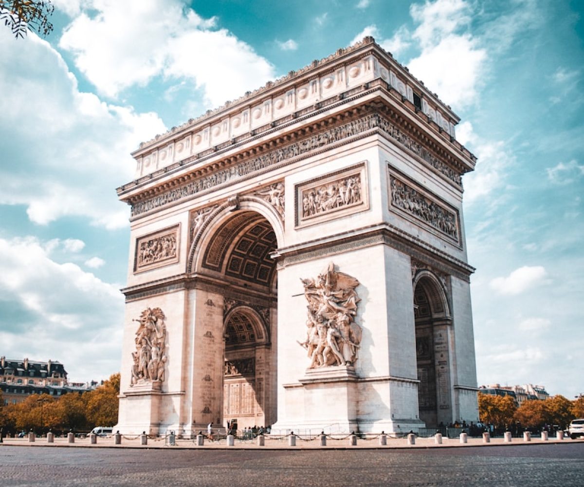 white concrete arc under blue sky and white clouds during daytime