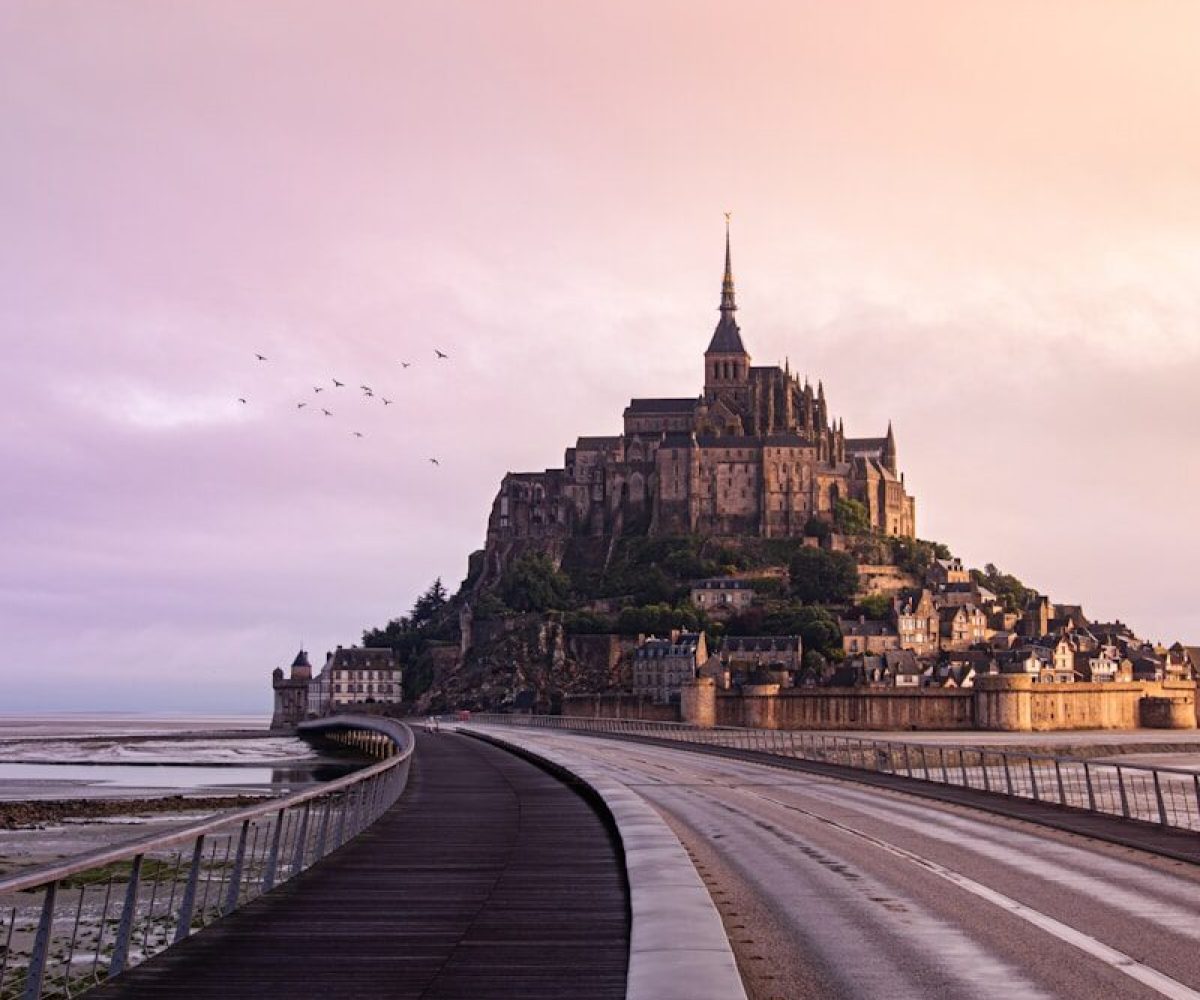brown concrete building near body of water during daytime
