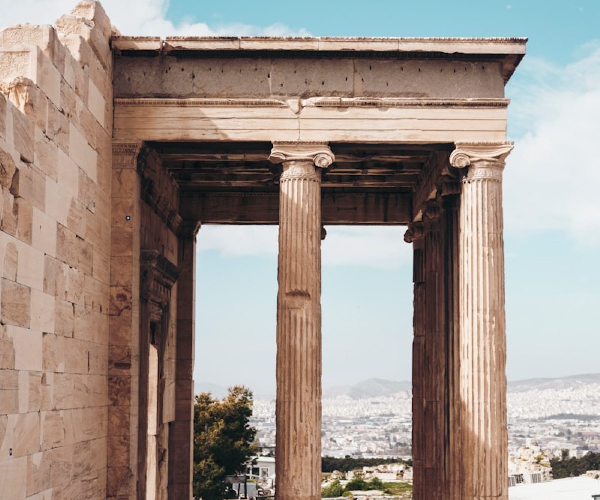 gray concrete building under white and blue cloudy sky